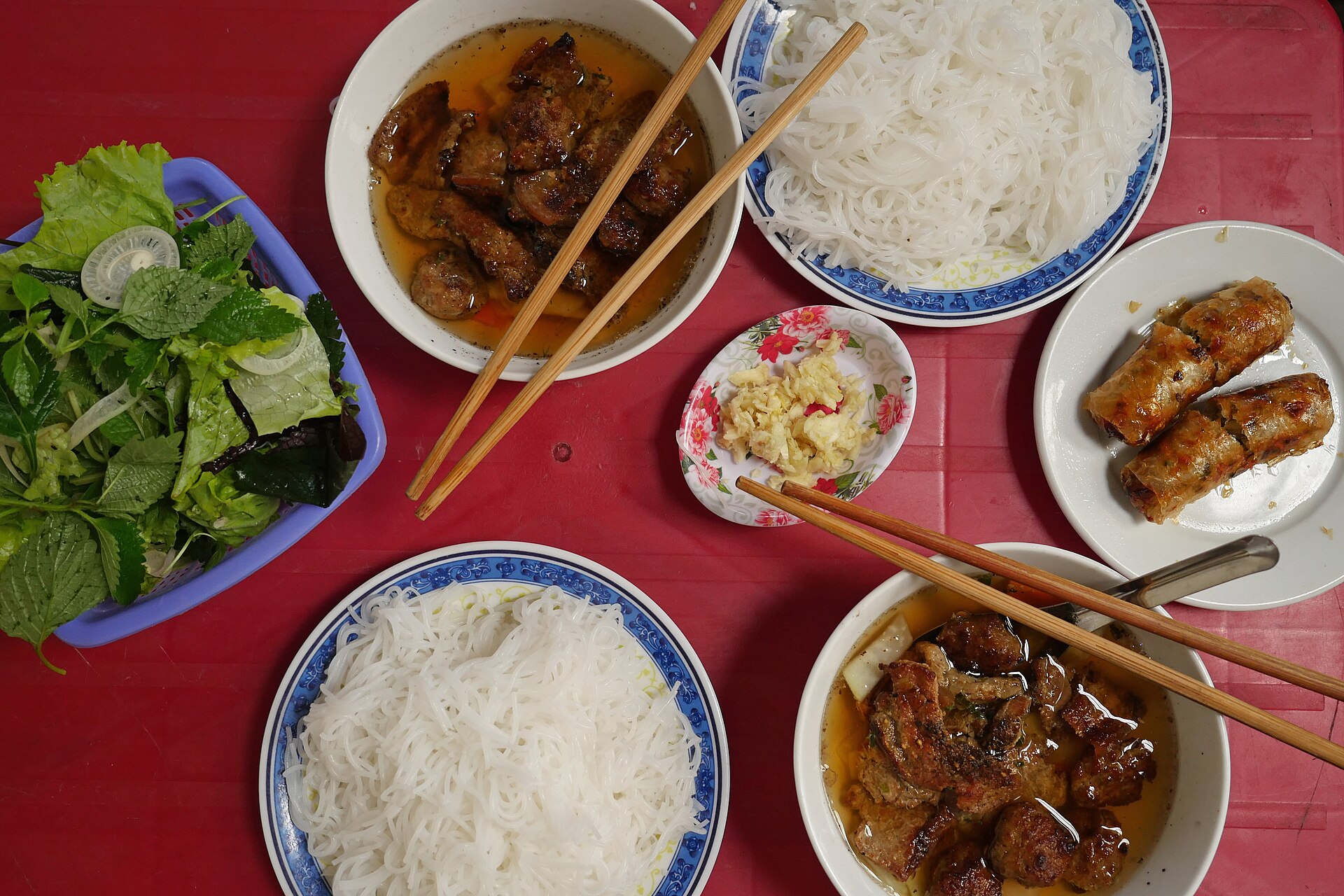 Bowls of grilled pork, rice noodles and fresh herbs served as bún chả in Hanoi.