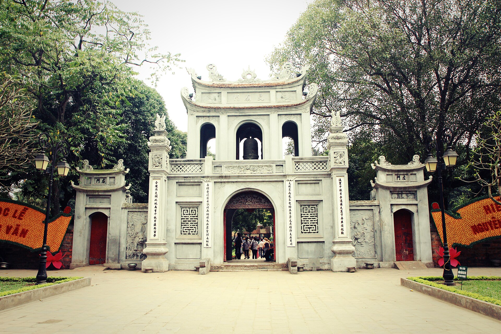 The ornate entrance gate of Hanoi’s Temple of Literature, framed by leafy trees.