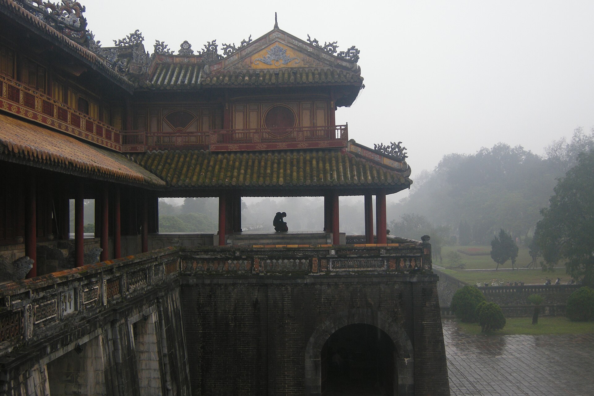 The upper pavilion and brick arch of Ngọ Môn, the Meridian Gate of Huế’s Imperial City, on a misty day.