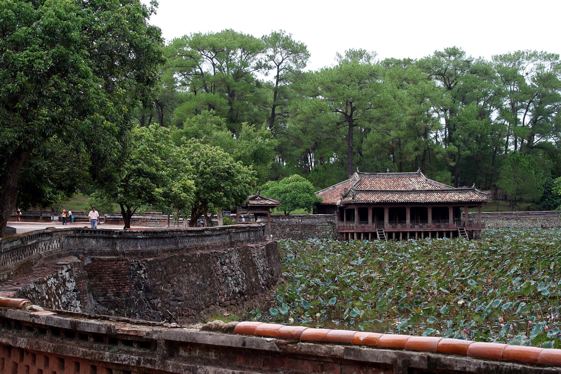 A tiled pavilion beside a lotus-filled lake in the Tự Đức tomb complex in Huế.