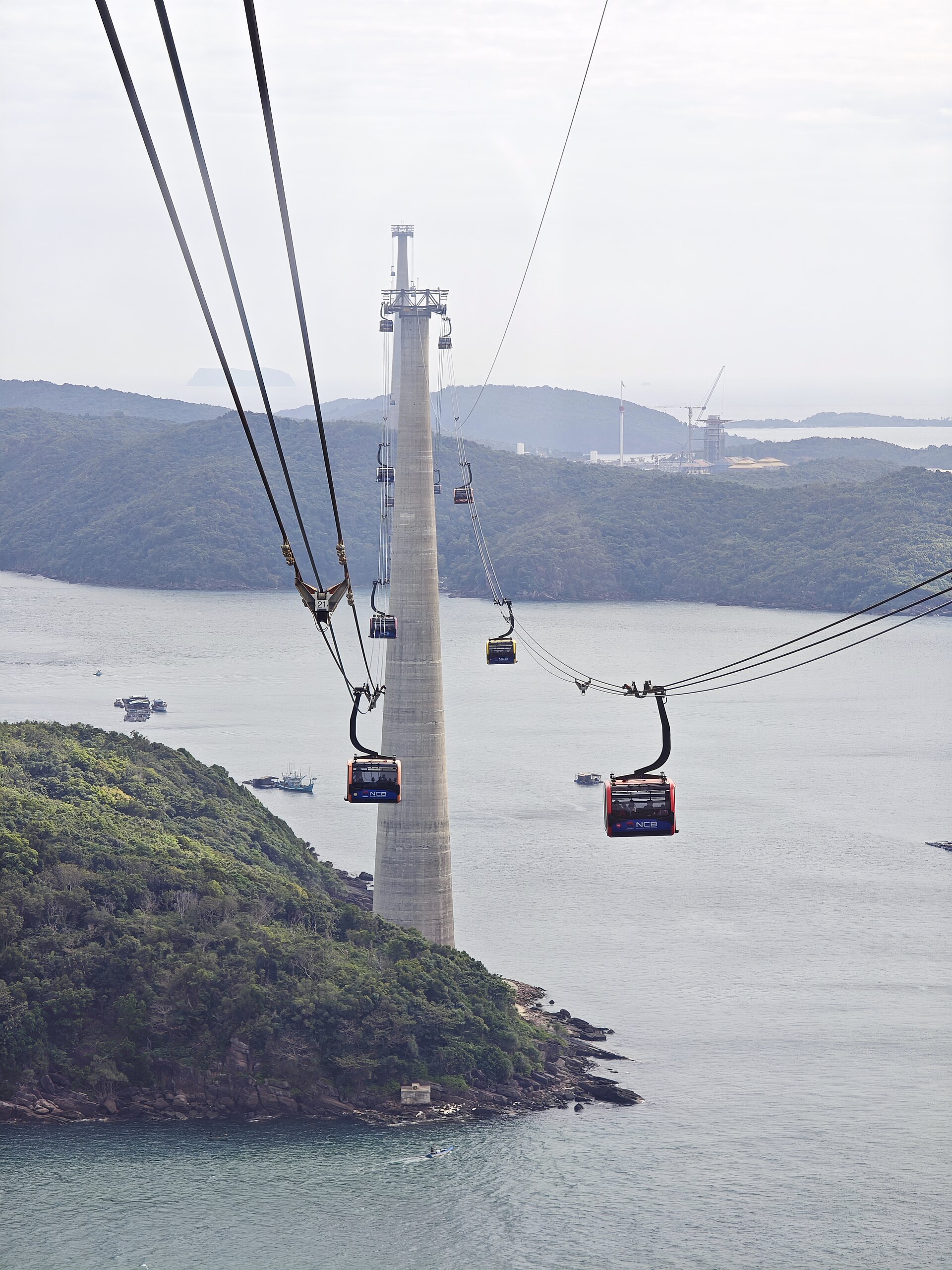 Cable-car cabins travel above the sea and wooded islands on the Hòn Thơm route.